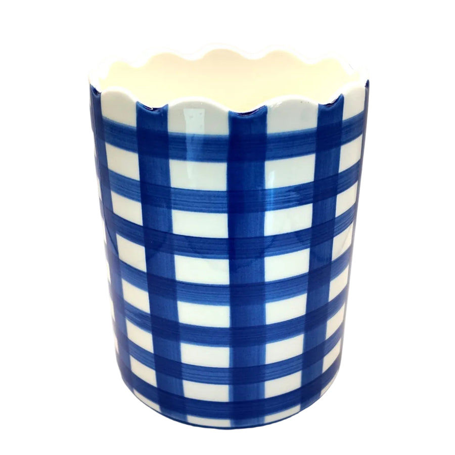 Ceramic vase with blue and white checkered pattern on a beige background