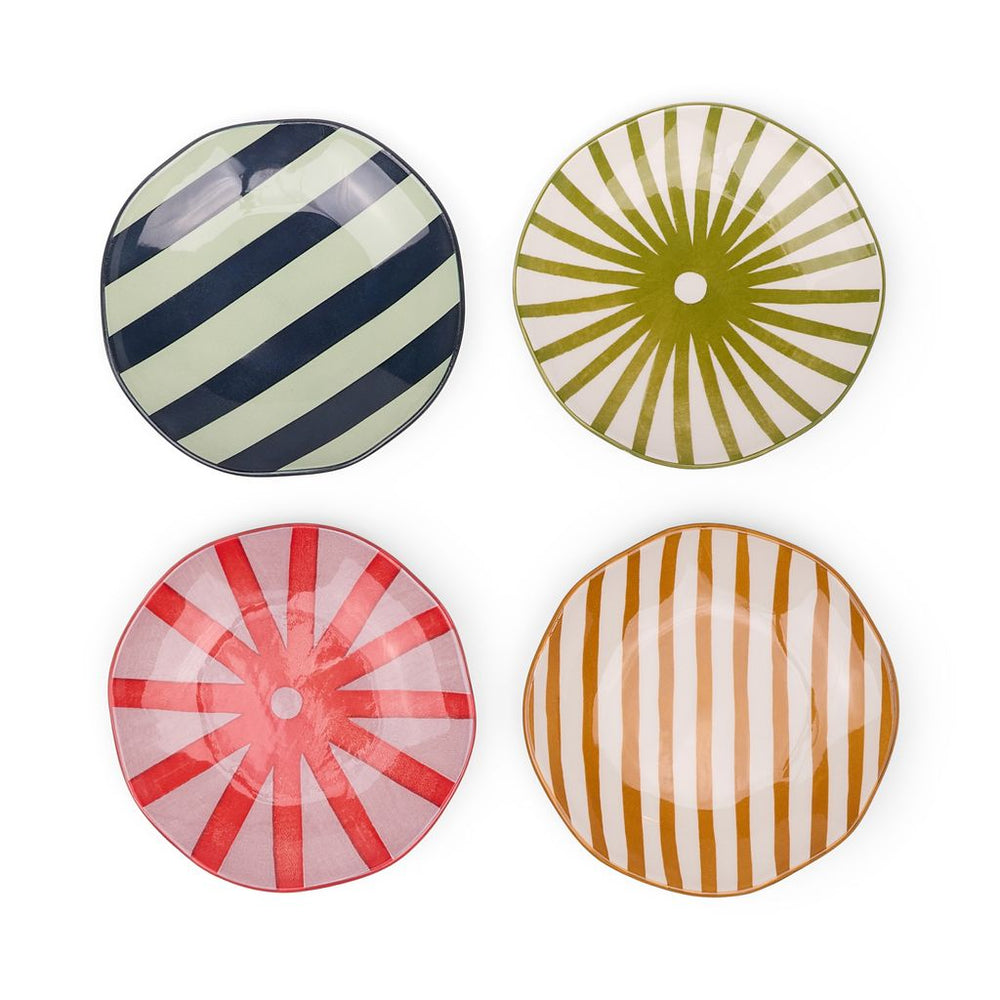 Four appetizer plates on a white background