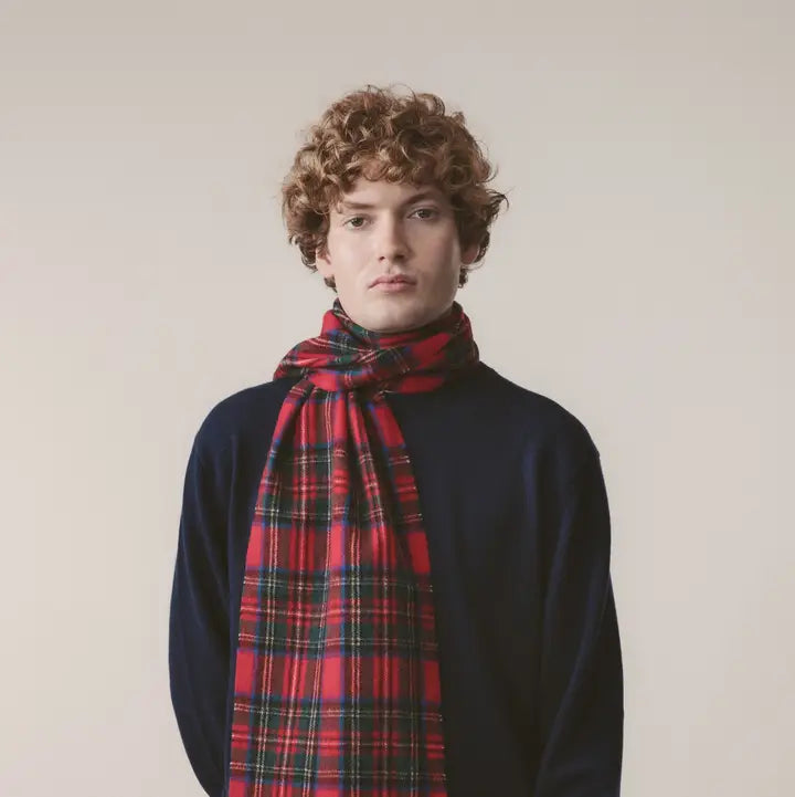 Person wearing a red plaid scarf against a plain background