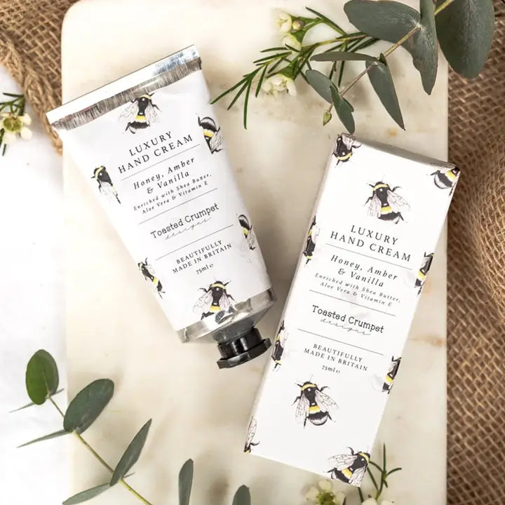 A tube  of Luxury Hand Cream & a box with bee design on a neutral background
