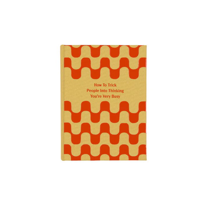 Book with red wavy pattern on beige cover and text 'How To Trick People Into Thinking You're Very Busy'.