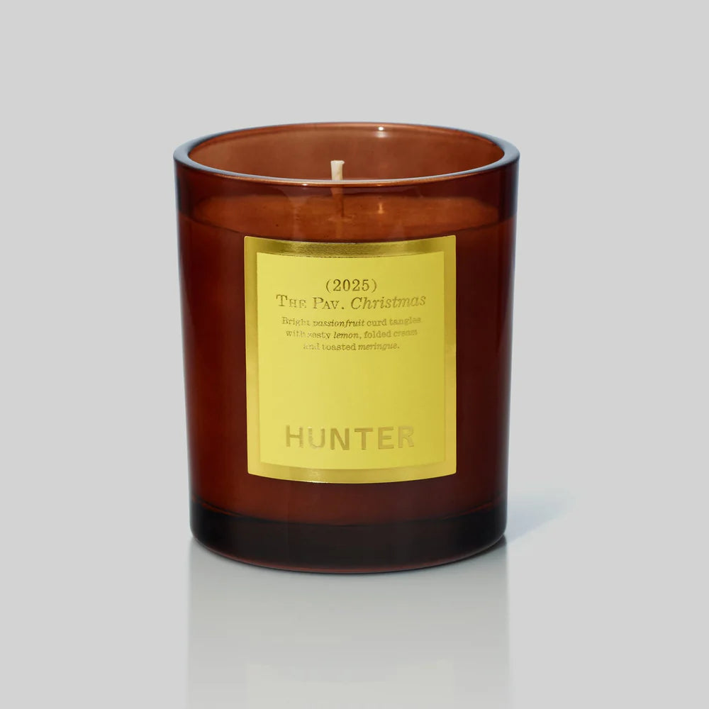 Candle with a gold label on a gray background