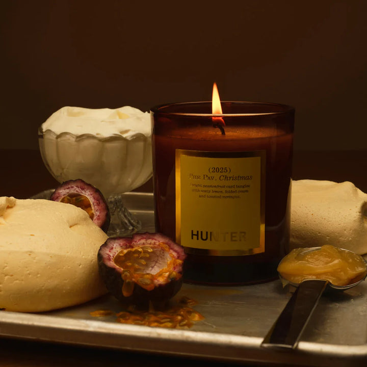 Candle with a label on a tray with fruits and a spoon