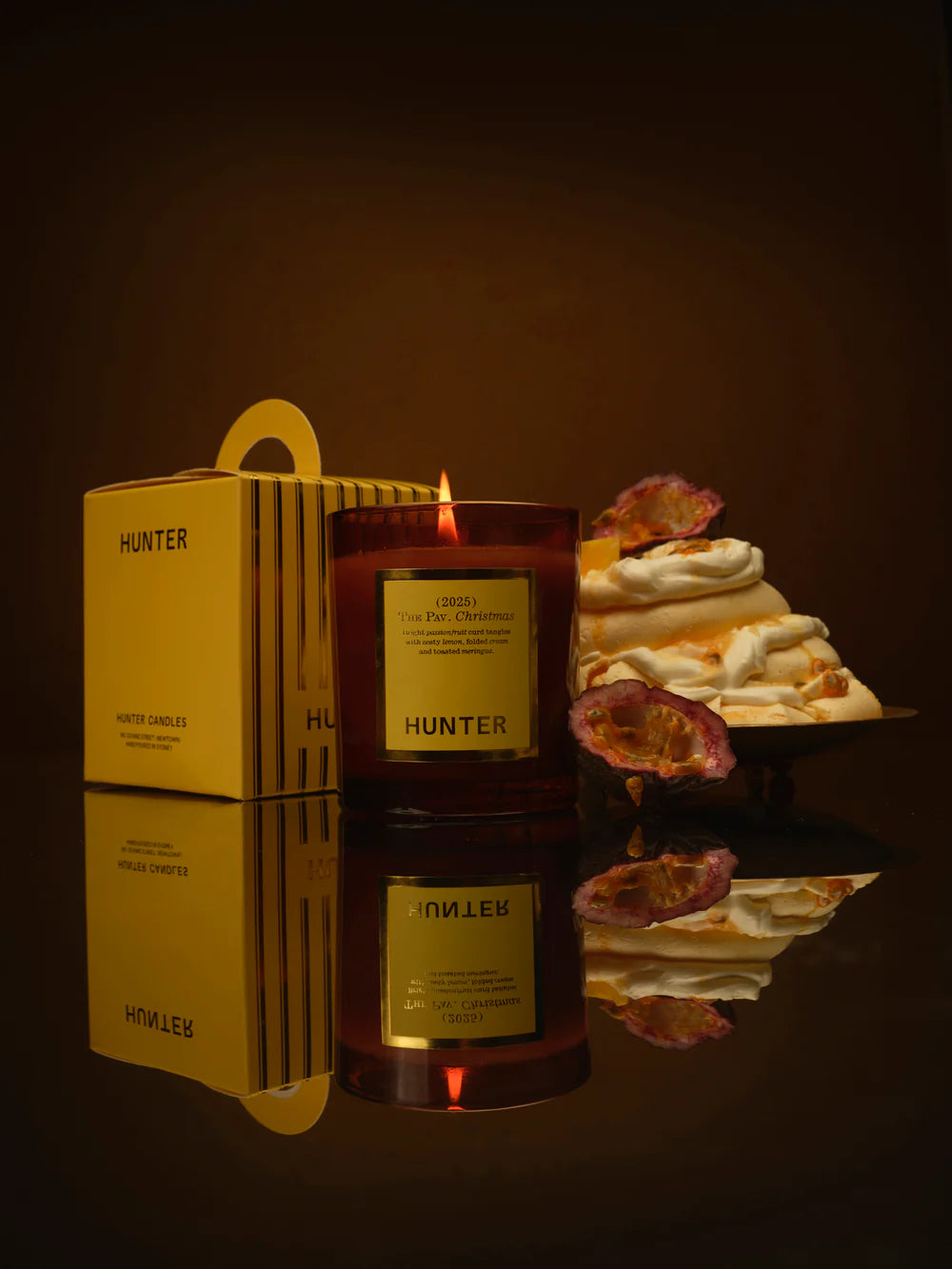 Hunter candle with packaging and decorative elements on a dark background