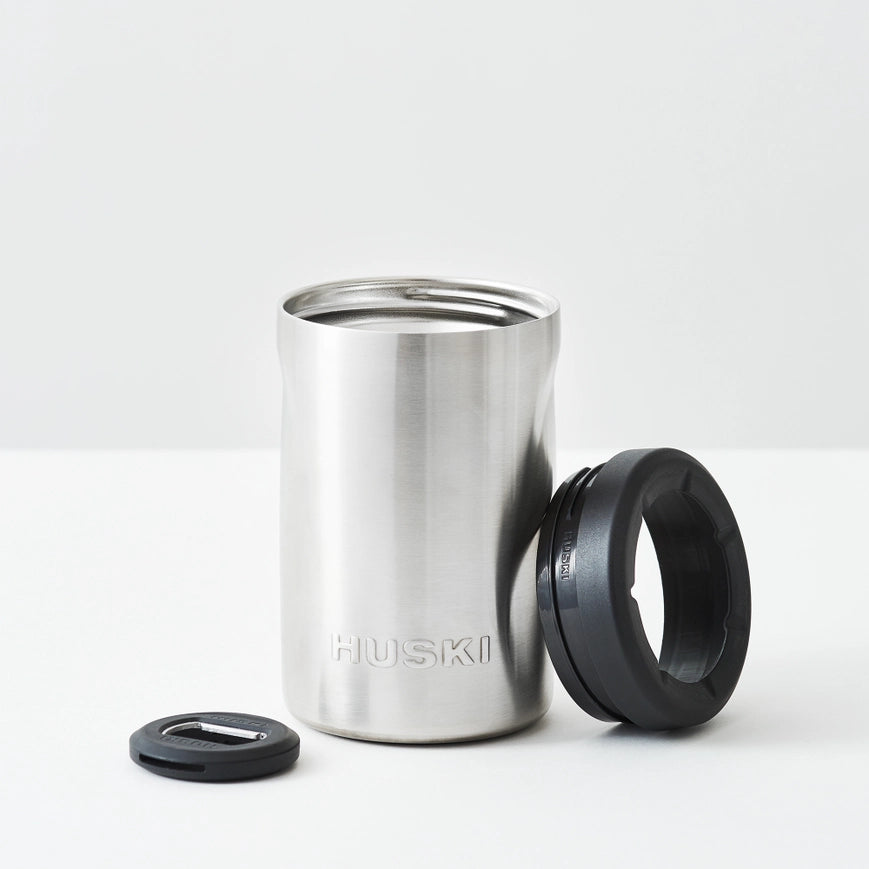 Stainless steel tumbler with black lid on a white background