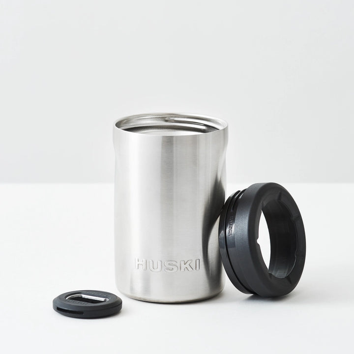 Stainless steel tumbler with black lid on a white background