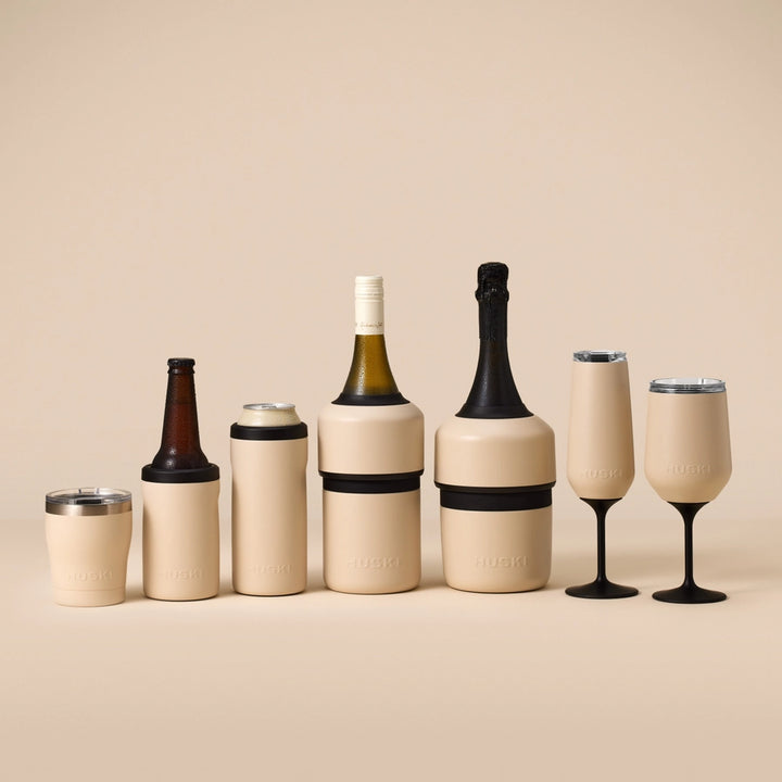 Set of beige drink containers including bottles and glasses on a beige background