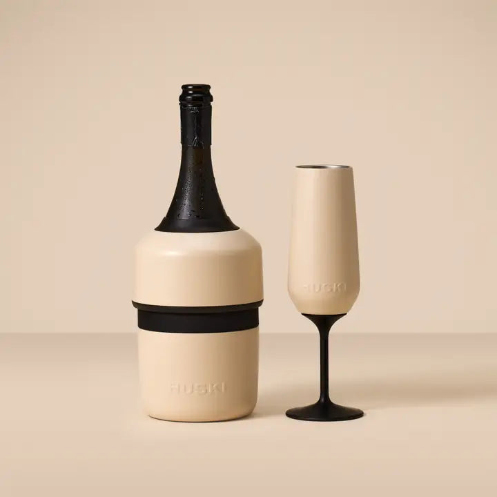 Champagne bottle and glass with 'Huski' branding on a beige background
