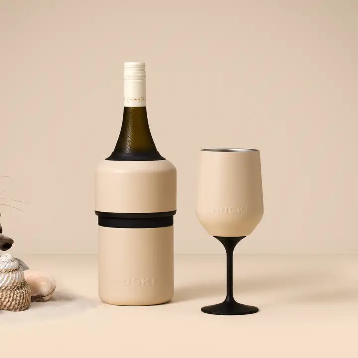 Wine bottle and glass with HUSKI branding on a beige background