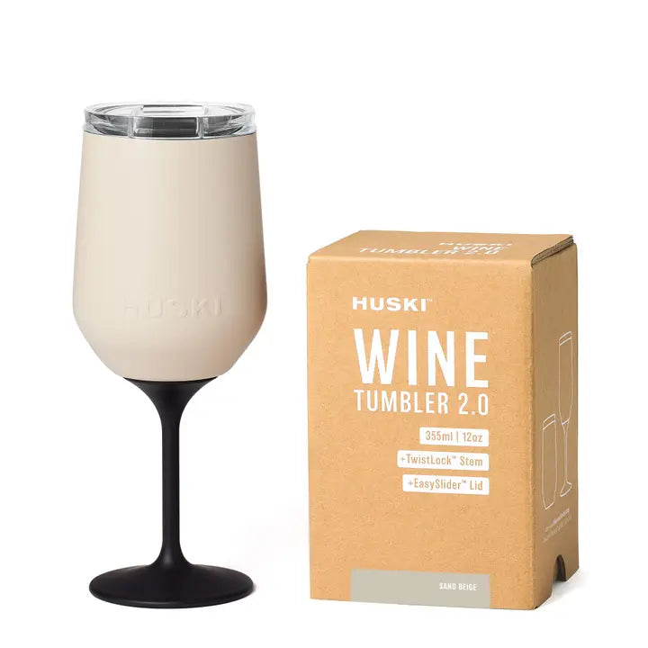 Huski Wine Tumbler 2.0 with beige interior and black stem, next to its packaging box on a white background.