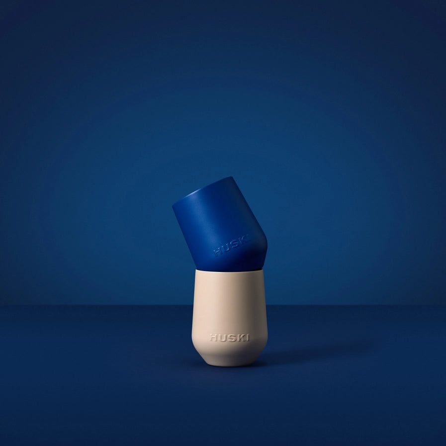Blue and beige dog toy with 'Huski' branding on a blue background