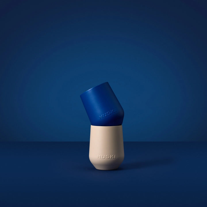 Blue and beige dog toy with 'Huski' branding on a blue background