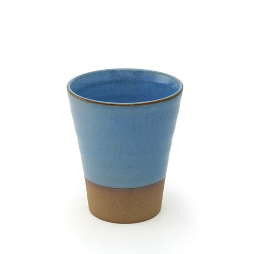 Blue ceramic cup with brown base on a white background
