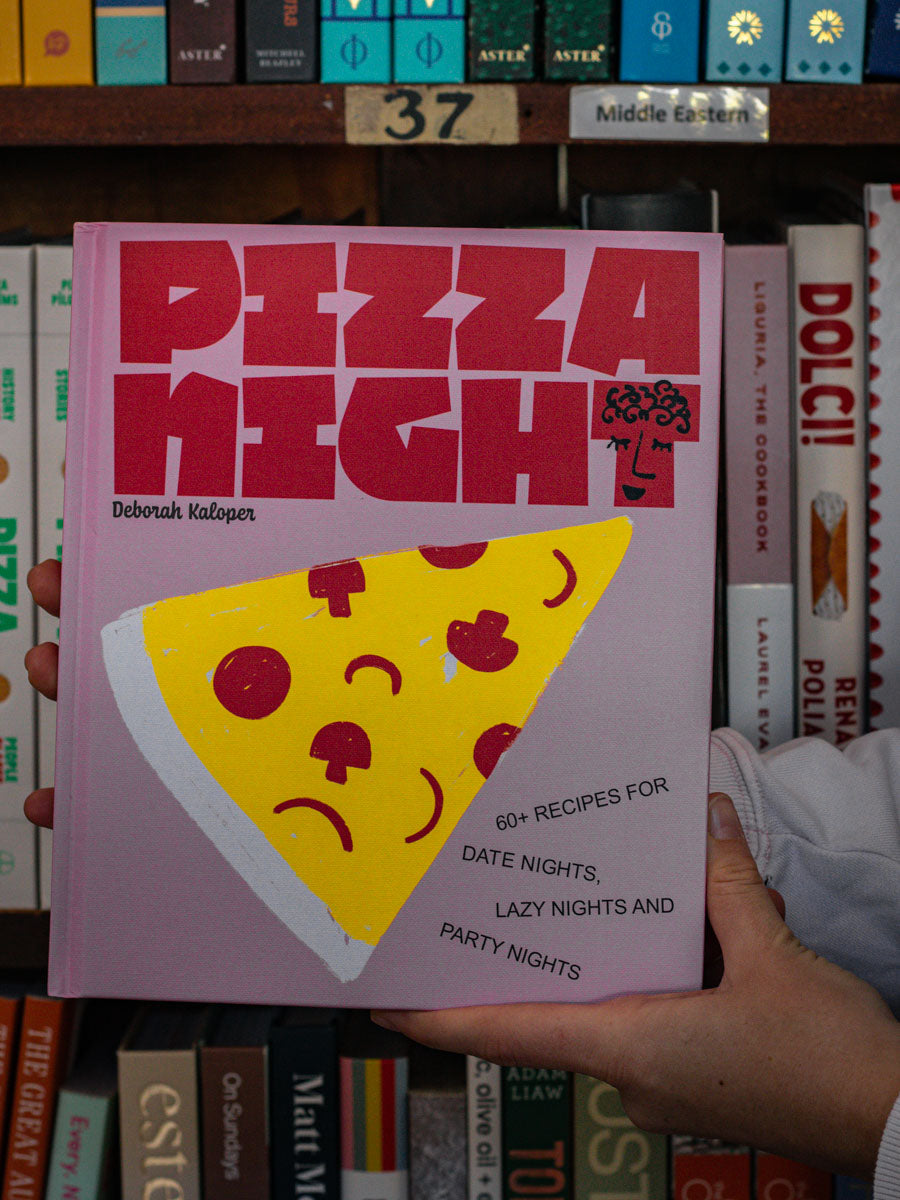 Someone holding Pizza Night cookbook by Deborah Kaloper