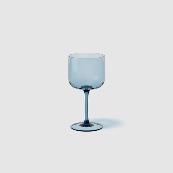 Blue wine glass on a light gray background