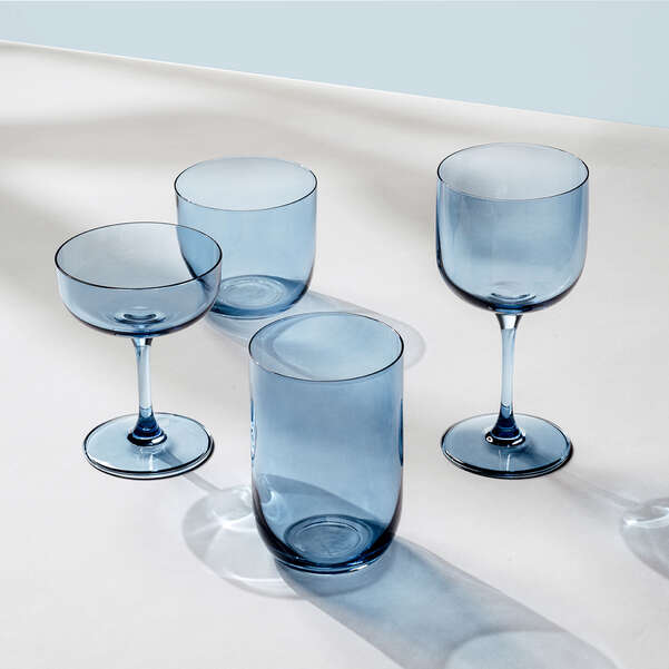 Set of four blue glasses on a light background
