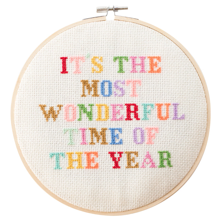 Embroidery hoop with colorful text 'IT'S THE MOST WONDERFUL TIME OF THE YEAR' on a white background