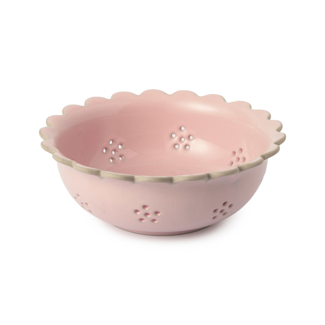Pink colander with scalloped edge on a white background