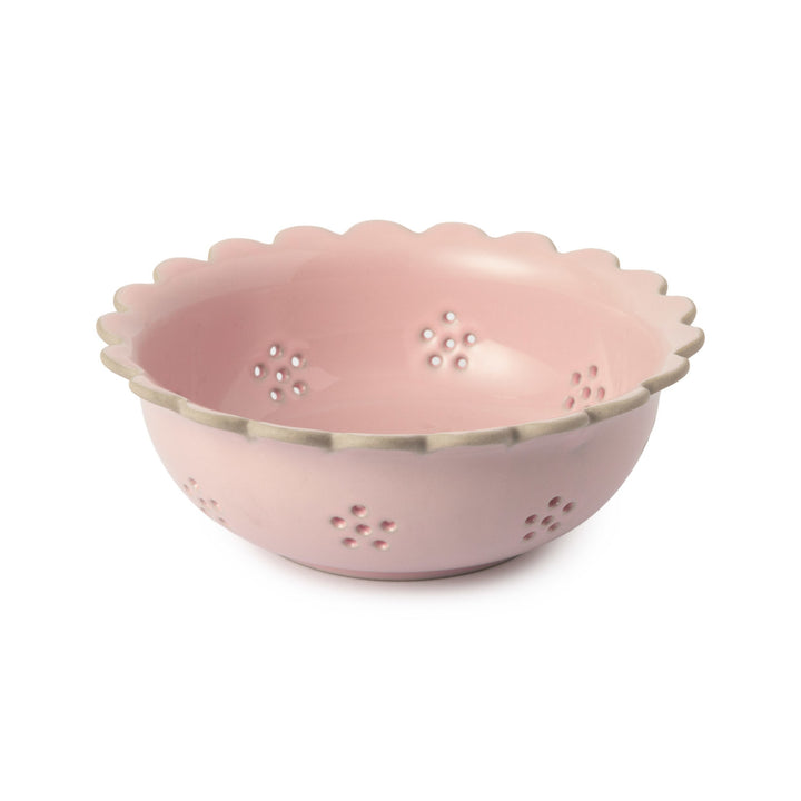 Pink colander with scalloped edge on a white background
