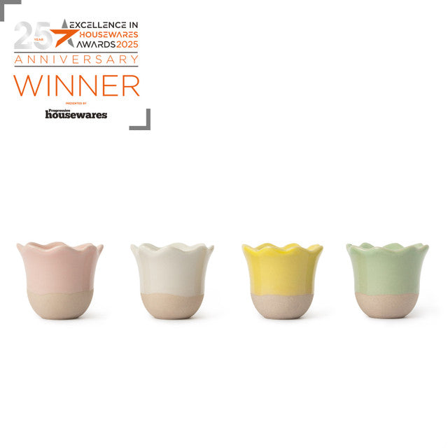 Four colorful ceramic cups with a &