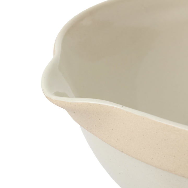 Close-up of a ceramic mixing bowl  with a two-tone design on a white background