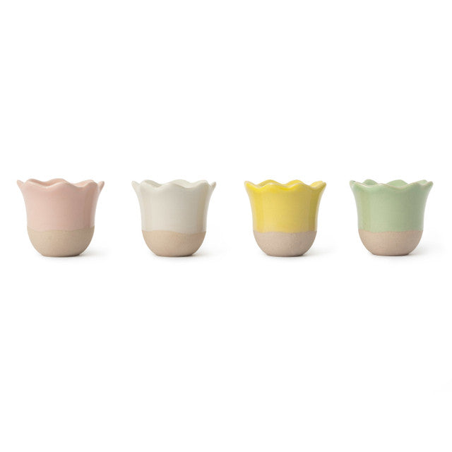 Set of four colorful ceramic egg cups on a white background