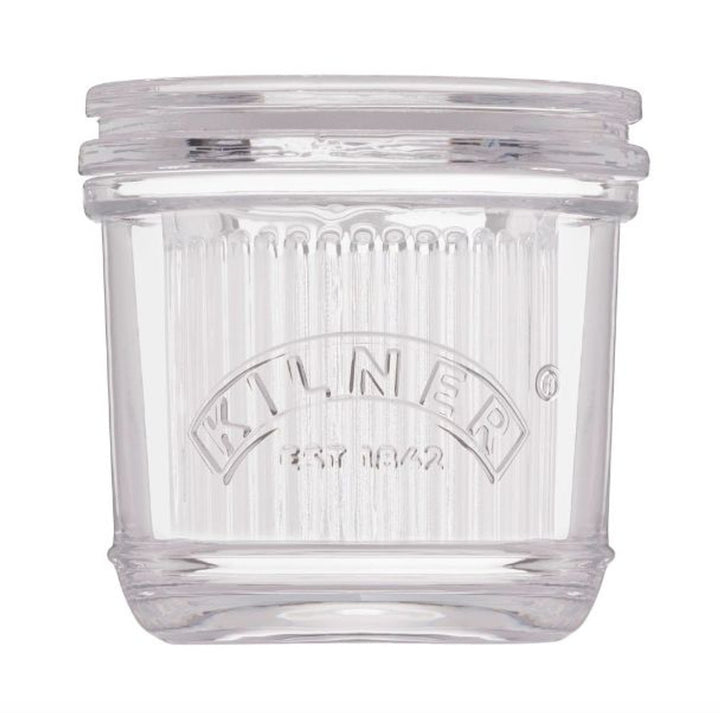 Clear glass butter crock with Kilner logo on a white background