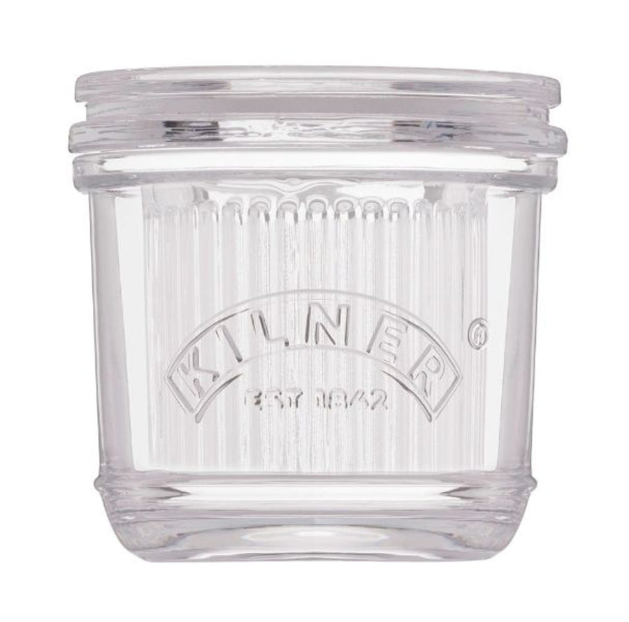 Clear glass butter crock with Kilner logo on a white background