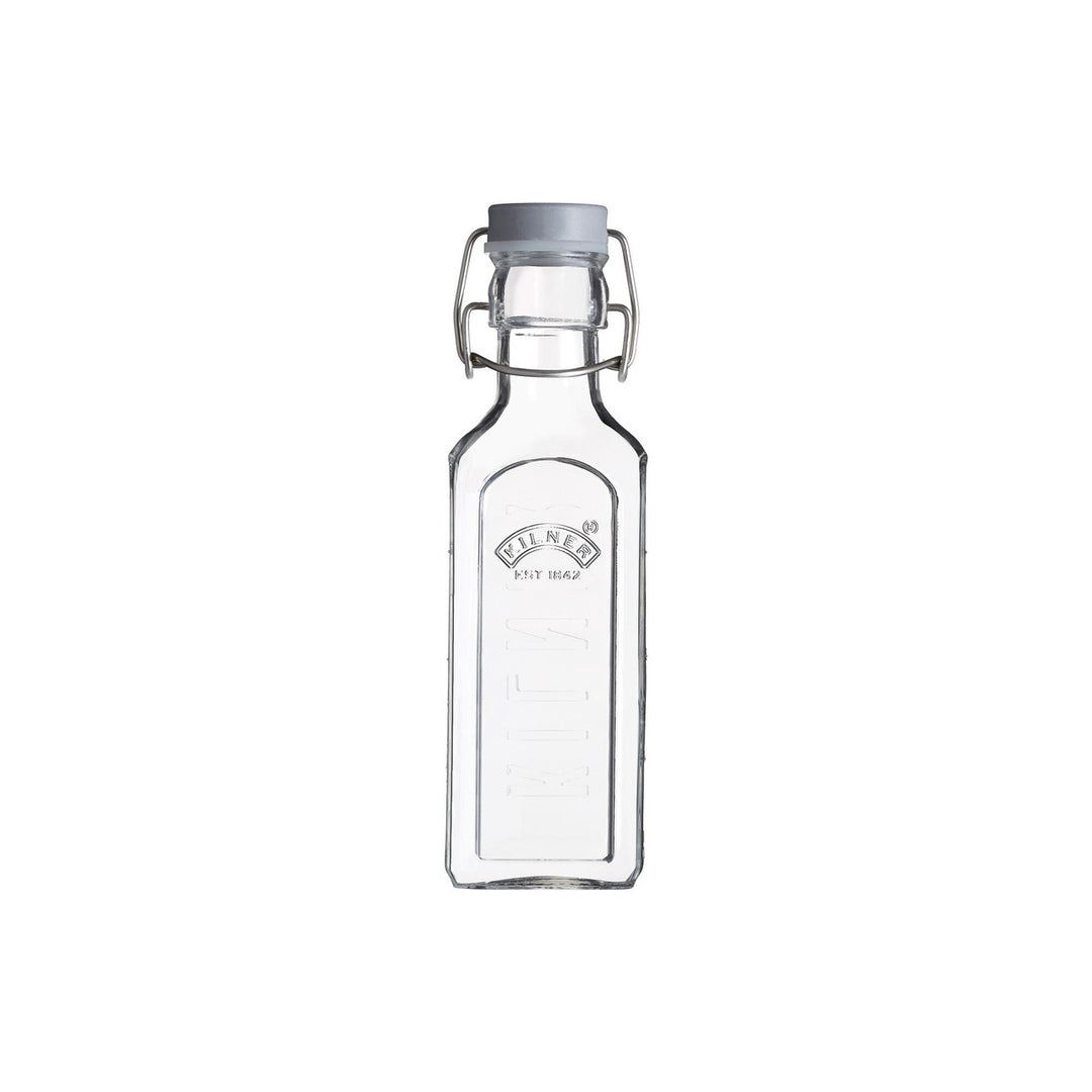 Clear glass bottle with a metal cap on a white background