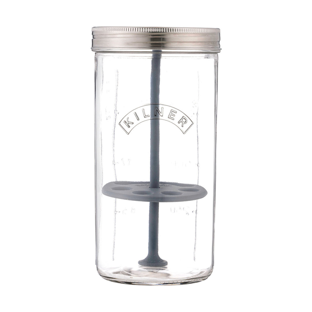 Clear glass jar with a metal lid and gray silicone components on a white background