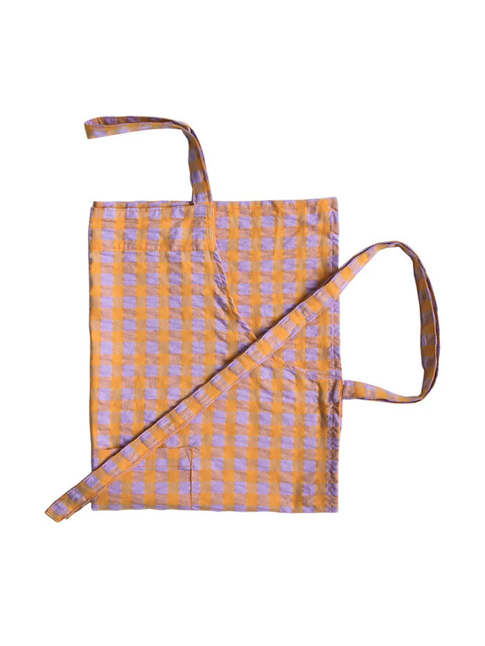 Yellow and purple checkered apron with a strap on a white background