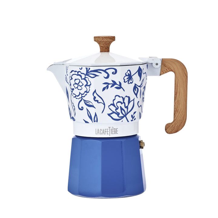 Blue and white floral-patterned coffee maker with wooden handle on a white background