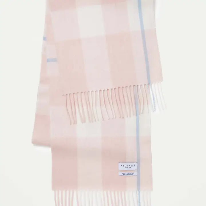 Pink and white plaid scarf with fringes on a light pink background