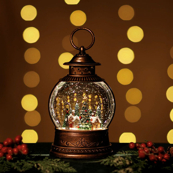Decorative lantern with a Christmas scene inside, surrounded by blurred lights on a dark background