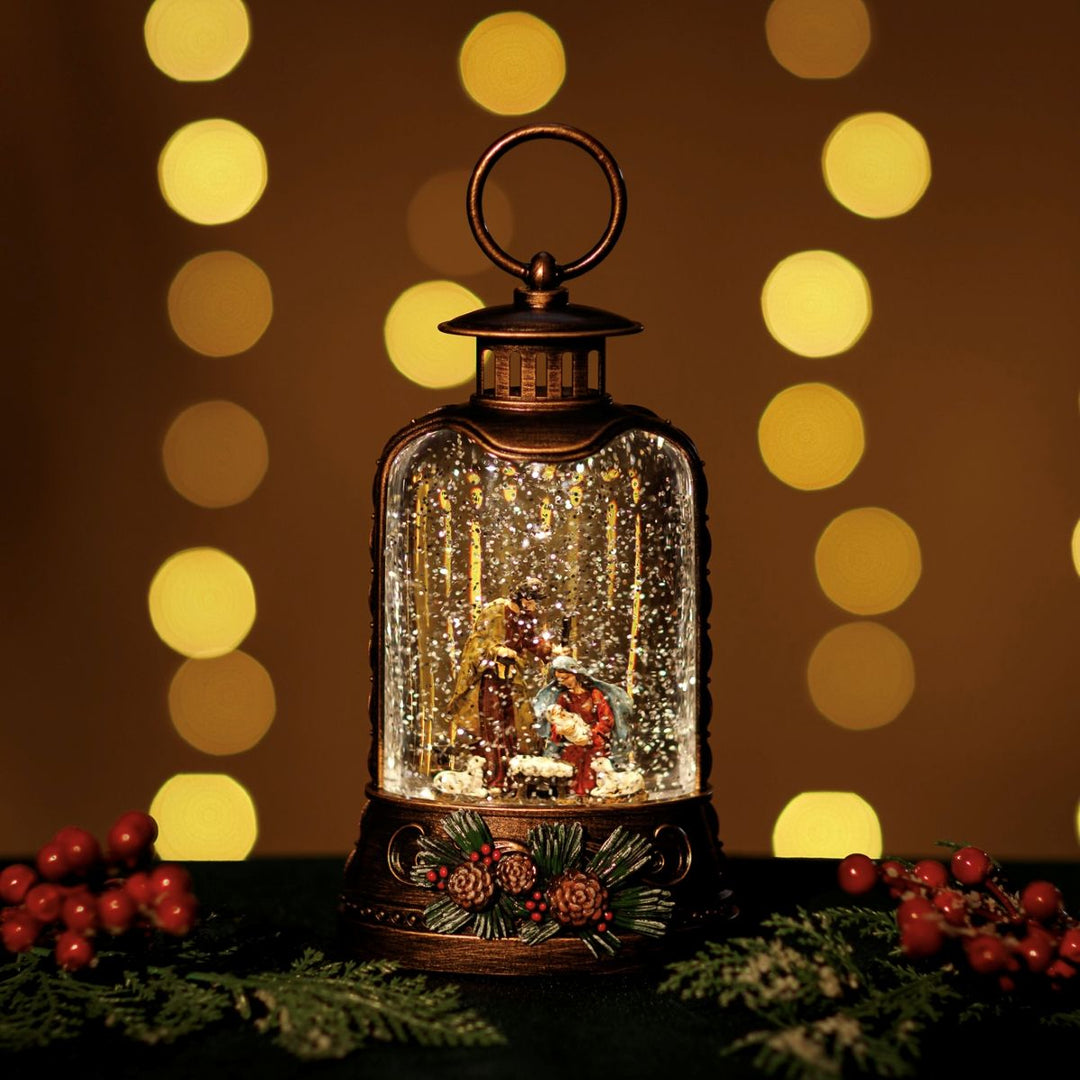 Decorative lantern with a Christmas scene inside, surrounded by festive decorations and lights.