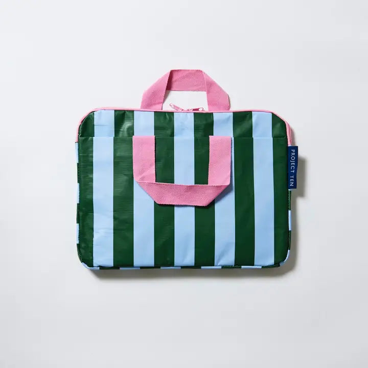 Striped bag with pink handles on a light gray background