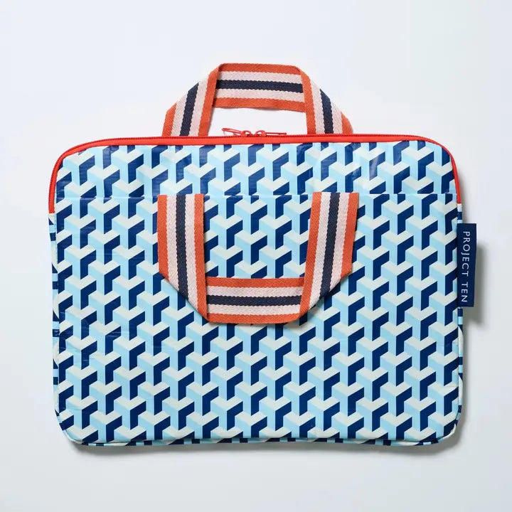 Patterned laptop sleeve with handle and visible brand tag on a light gray background