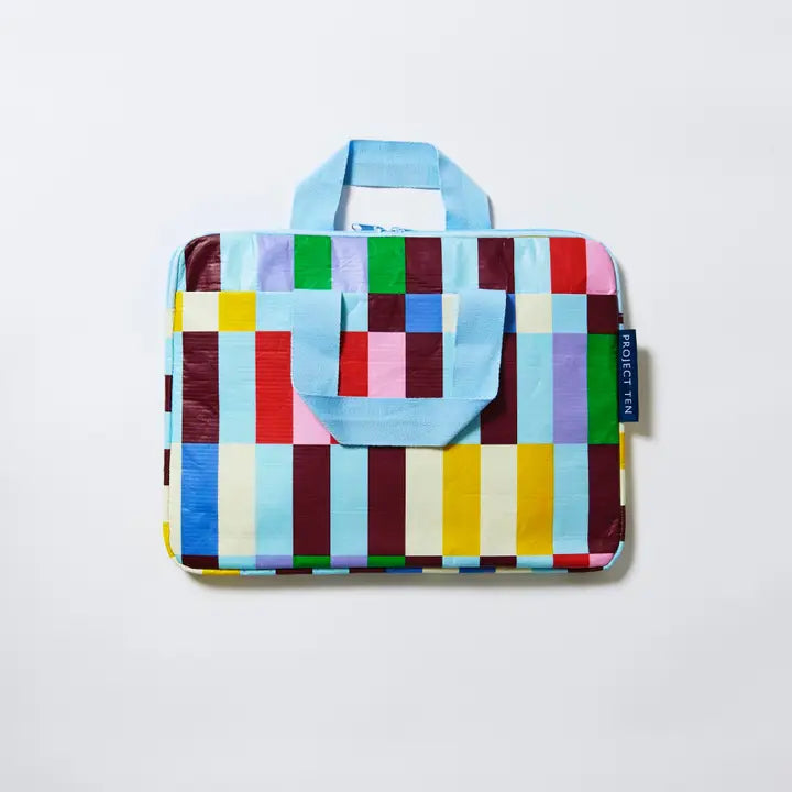 Colorful checkered bag with a handle on a light gray background
