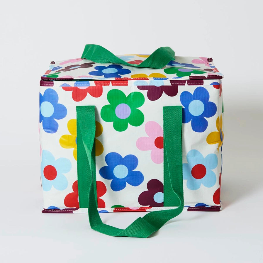 Colorful floral-patterned cooler bag with green handles on a white background