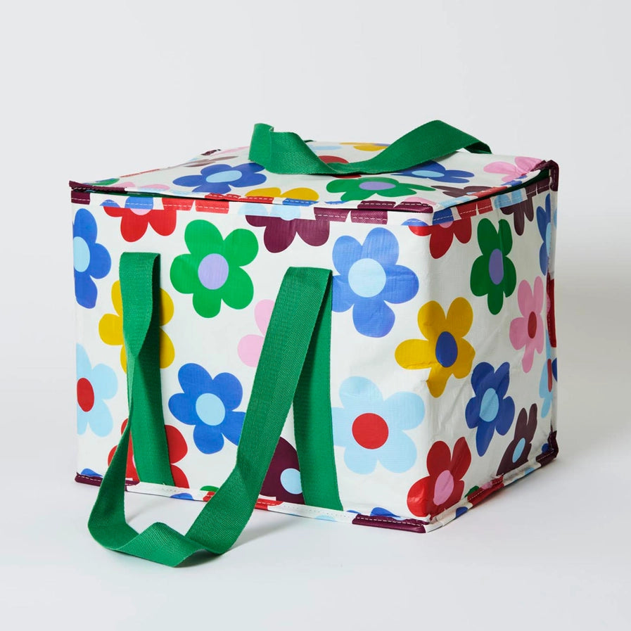 Colorful floral-patterned cooler bag with green handles on a white background