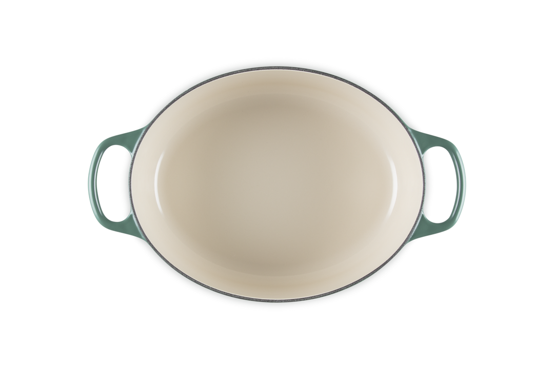 Green enameled cast iron baking dish on a white background