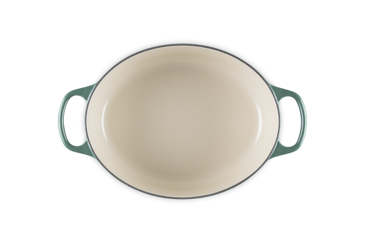 Green enameled cast iron baking dish on a white background