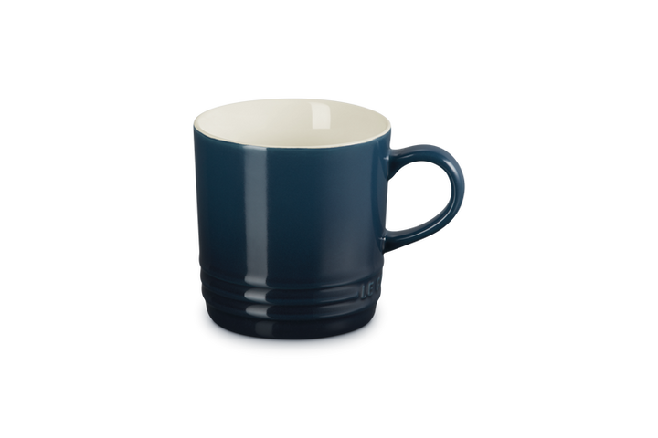 Blue mug with a white interior on a white background