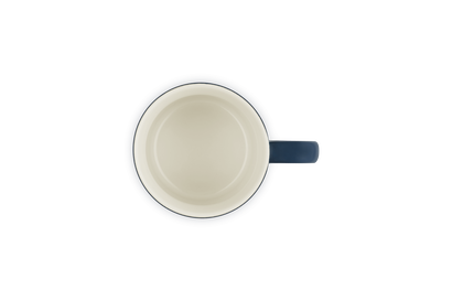 Ceramic mug with a blue handle on a white background