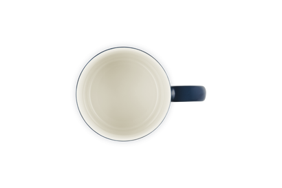 White mug with a blue handle on a white background