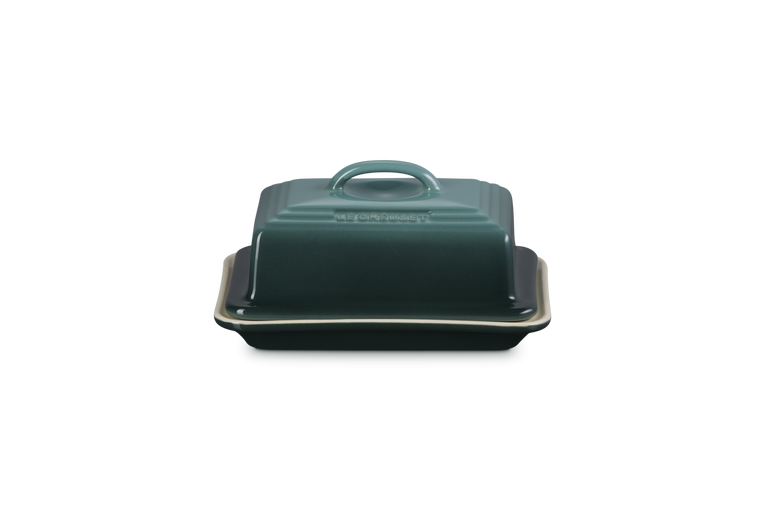 Dark green ceramic butter dish with lid on a white background
