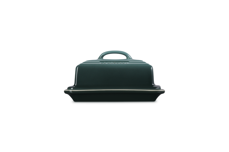 Green butter dish with lid on a white background
