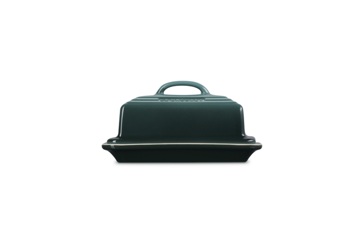 Green butter dish with lid on a white background