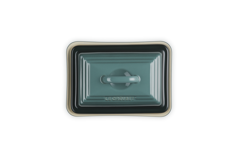 Rectangular ceramic butter dish with lid on a white background