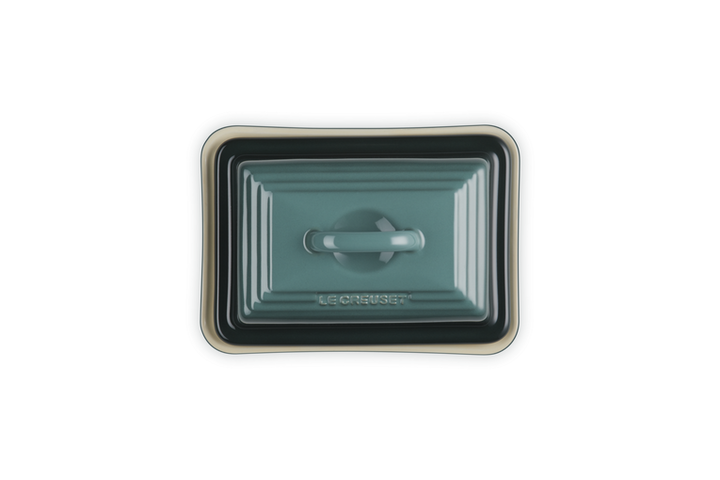 Rectangular ceramic butter dish with lid on a white background